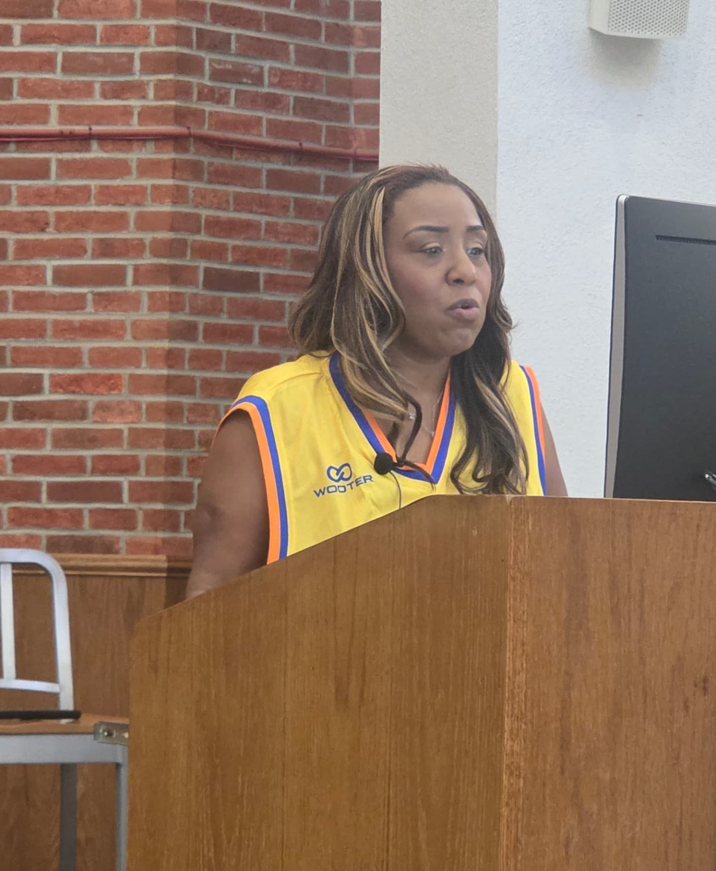 Speaker at the podium in a Lemonade jersey